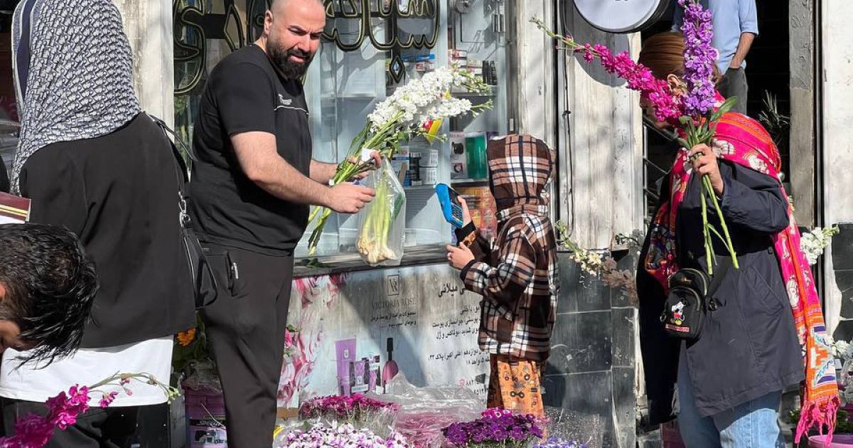 A man is selling flowers to customers at Tehran's Flower Market on Friday, 20 March 2026 (Photo/Govt. of Iran/Atena Salarvand)